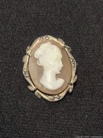 Front view of oval shell cameo brooch-pendant