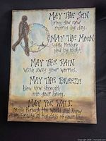 Full view of signed mixed media canvas with text and figure