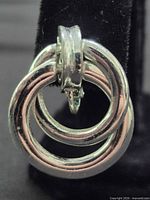 Front view showing double-hoop design and silver-tone finish