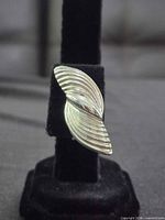 front view of one earring on stand