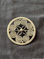 Front view showing spiral design and patina