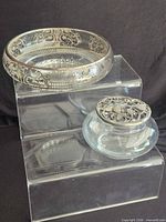 Jar and bowl together displaying shapes and silver accents