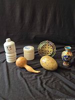 Group view showing ceramic bottle/vase and wooden egg