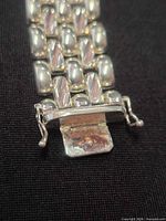 Close-up of bracelet clasp showing link construction and 925 hallmark