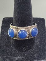 Front view showing three blue cabochons set in silver band