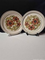 Front view of both matching floral stoneware plates