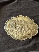 Front view showing detailed figural scene and border