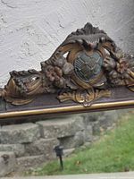 close-up of crest with floral and cartouche detail