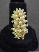 Front view showing clustered faux pearls on one earring