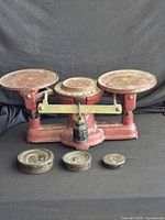 Overall view of balance scale with three weights in front