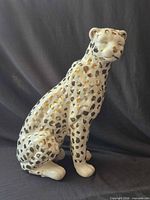 Full view of seated porcelain leopard figurine