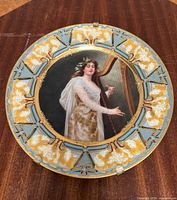 Full view of porcelain plate showing portrait and decorative border