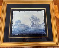 Framed Delft plate, frontal view highlighting artwork and frame