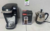 Keurig brewer, boxed Bodum French press, Farberware percolator side by side