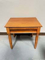 front view of handmade maple side table showing drawer and legs
