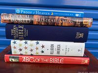 Stack of five religious books showing spines with titles