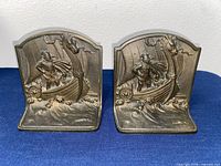 Front view of both cast iron Viking ship bookends