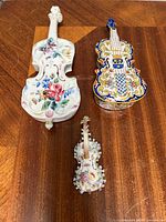 All three ceramic violin pieces side by side