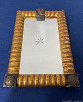 Front view of small gold framed mirror
