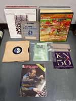 Group shot of all vinyl records, booklets, magazine and Recordio disc