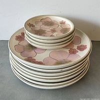 Stacked view showing all 11 Denby Gypsy plates, size differentiation visible