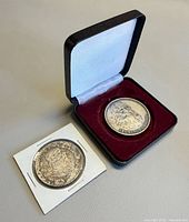 Both coins: Da Vinci medal in case, Mexico Peso in holder