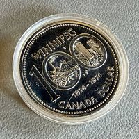 Reverse view of 1974 Winnipeg Centennial silver dollar in capsule