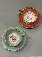 Top view of both teacup sets displaying interiors and saucers