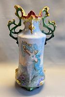 Full front view of porcelain vase showing painted scene and handles
