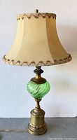 Full view of brass table lamp with shade