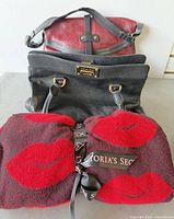All three items grouped: Victoria’s Secret wrap scarf, Saki red leather bag, Michael Kors black bag