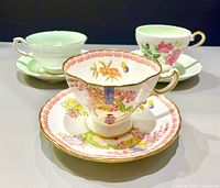 Front view of three teacup and saucer sets
