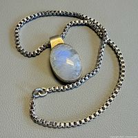 Full view of necklace showing moonstone pendant and box chain