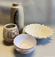 Group shot of all four pieces: barrel cup, vase, sunflower dish, handled bowl