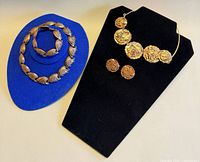 Overall view of both jewelry sets on display forms