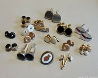 All cufflinks and studs laid out on surface