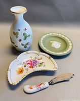Group shot of all four items: Royal Crown Derby dish, spreader, Wedgwood vase, Wedgwood jasperware dish