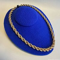 Full view of necklace laid on display pad