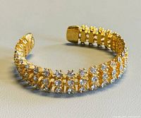 Front angled view of gold-tone cuff showing rhinestone rows