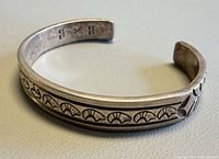 Side view of cuff showing stamped motifs and hallmark
