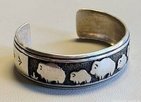 Full view of sterling silver cuff showing buffalo motif and interior