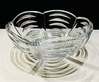 Angled view showing exterior cut arches and scalloped rim of crystal bowl