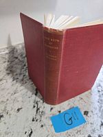 Spine and covers of red cloth hardcover “The Keys of Paradise”.