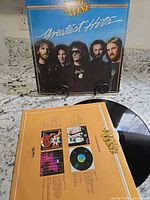 Front and back sleeve views with vinyl partially visible