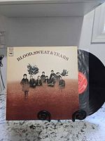 Front cover of Blood, Sweat & Tears LP on stand, vinyl partially removed