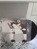 Front jacket of Box of Frogs LP with vinyl partially exposed