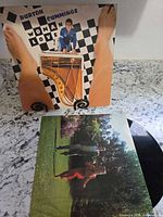 Front album cover with Woman Love artwork