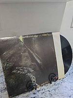 Front cover of album jacket with vinyl partially visible