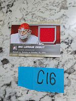 Front of Chris Osgood jersey card showing red fabric swatch and printed details