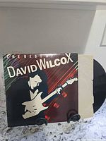 Front cover and vinyl partially exposed on stand